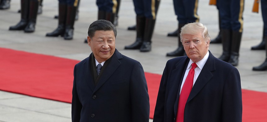 U.S. President Donald Trump, right, walks with Chinese President Xi Jinping during a welcome ceremony at the Great Hall of the people in Beijing, Thursday, Nov. 9, 2017.