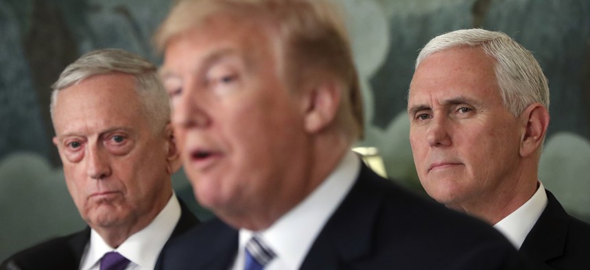 Defense Secretary Jim Mattis, left, and Vice President Mike Pence, right, listen to President Donald Trump, center, in the White House in Washington, March 23, 2018.