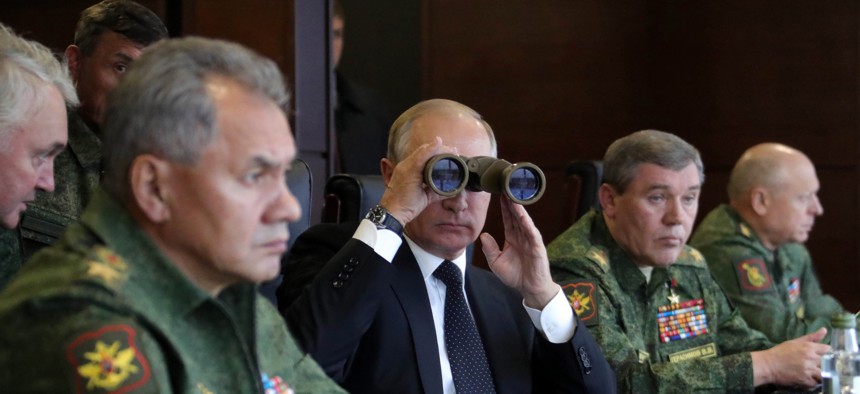 Russian President Vladimir Putin, center, Defence Minister Sergei Shoigu, left, and Chief of the General Staff of the Russian Armed Forces Valery Gerasimov, second right, watch a military exercise at a training ground at the Luzhsky Range. Sept, 2017.
