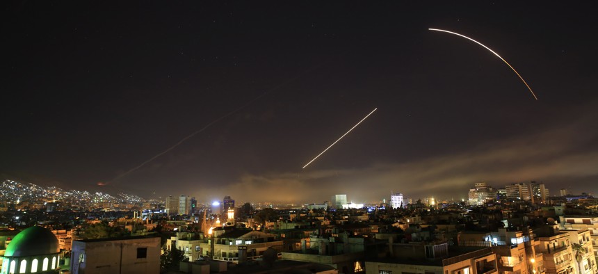 Missiles streak across the Damascus skyline as the U.S. launches an attack on Syria targeting different parts of the capital, early Saturday, April 14, 2018.