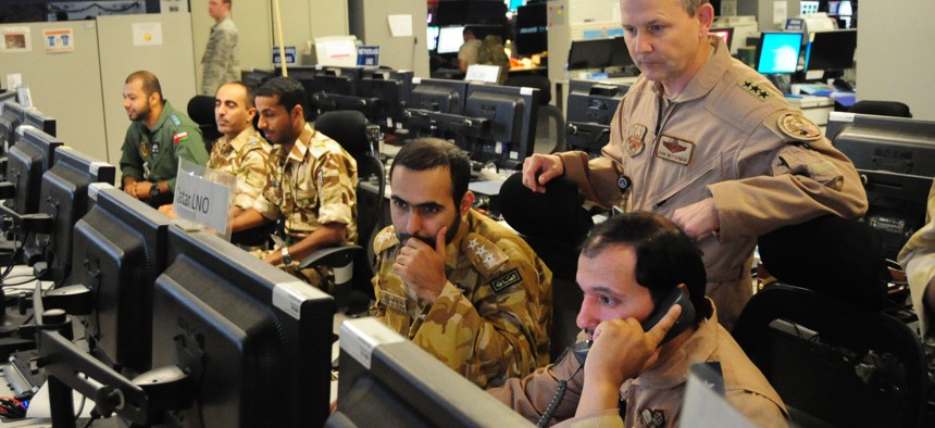 U.S. Air Forces Central Command commander Lt. Gen. John Hesterman III looks on as Gulf Cooperation Council liaison officers participate in an exercise at the Combined Air Operations Center, Nov. 26, 2014, at Al Udeid Air Base, Qatar. 