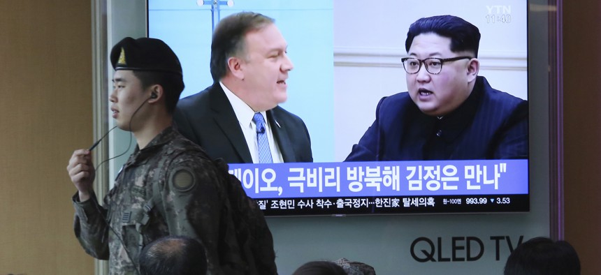Mike Pompeo, left, and North Korean leader Kim Jong Un during a news program at the Seoul Railway Station in Seoul, South Korea on April 18, 2018.