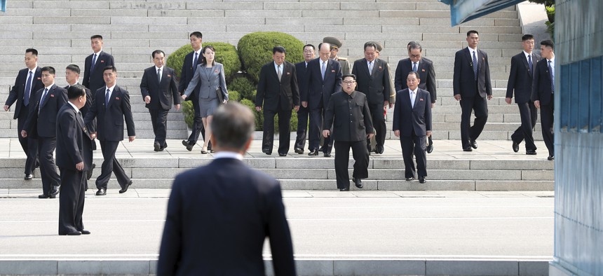 North Korean leader Kim Jong Un, center, walks toward South Korean President Moon Jae-in at the border village of Panmunjom in the Demilitarized Zone, South Korea, Friday, April 27, 2018.