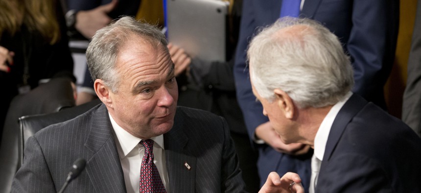 Senate Foreign Relations Committee Chairman Sen. Bob Corker, R-Tenn., right, confers with committee member Sen. Tim Kaine, D-Va. on Capitol Hill in Washington, Wednesday, Jan. 11, 2017