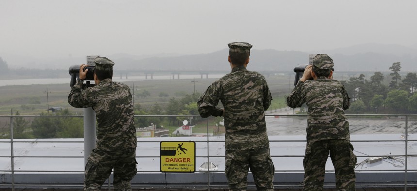 South Korean marine force members look toward North's side through binoculars at the Imjingak Pavilion in Paju near the border village of Panmunjom, South Korea, May 16, 2018.