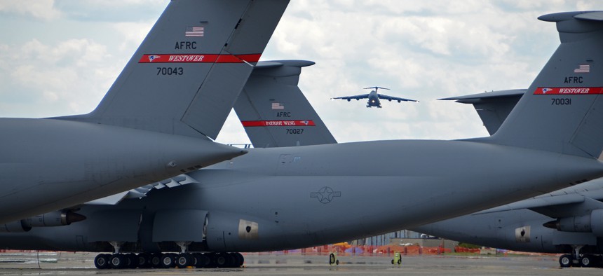 C-5 Galaxy tails on the flightline frame a C-5 on final approach to Westover Air Reserve Base.