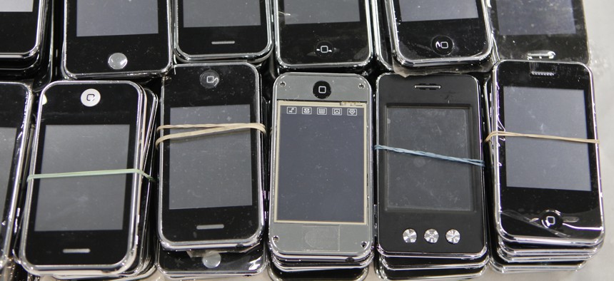 Los Angeles Port Police display seized counterfeit Apple iPhones during a news conference at the Port of Los Angeles Monday, Feb. 7, 2011. Authorities in the the Port of Los Angeles complex seized phony iPods, iPhones and other electronics.