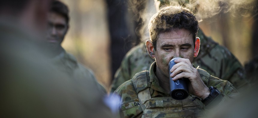 An Australian Army soldier of 2nd Battalion, the Royal Australian Regiment, drinks a hot coffee during orders at Shoalwater Bay Training Area in North Queensland during Exercise Talisman Saber 17 in 2017.