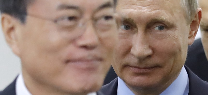 Russian President Vladimir Putin, right, and his South Korean counterpart Moon Jae-in arrive for their meeting at the Eastern Economic Forum in Vladivostok, Russia, on Wednesday, Sept. 6, 2017. 