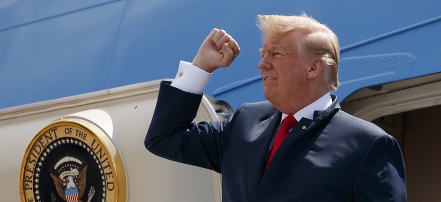 In this May 31, 2018, photo, President Donald Trump pumps his fist as he steps off Air Force One after arriving at Ellington Field Joint Reserve Base, in Houston. 