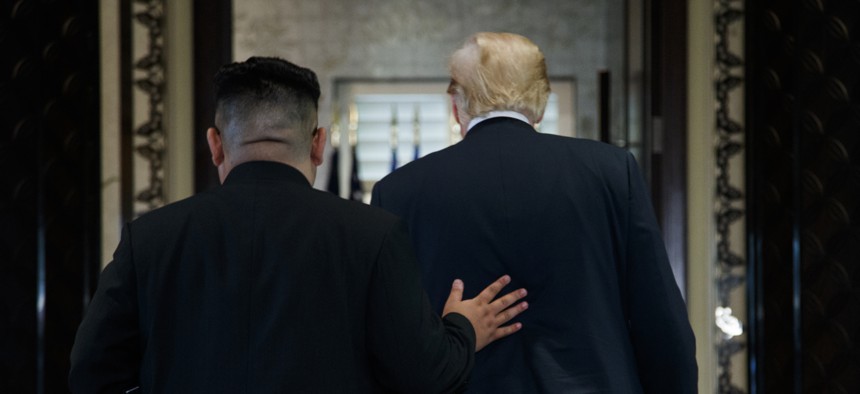 President Donald Trump and North Korean leader Kim Jong Un walk off after a signing ceremony during a meeting on Sentosa Island, Tuesday, June 12, 2018, in Singapore.
