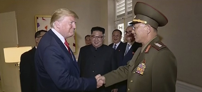 U.S. President Donald Trump shakes hands with No Kwang Chol, minister of People's Armed Forces of North Korea, as North Korean leader Kim Jong Un, center, introduces Trump to the general during the summit in Singapore.