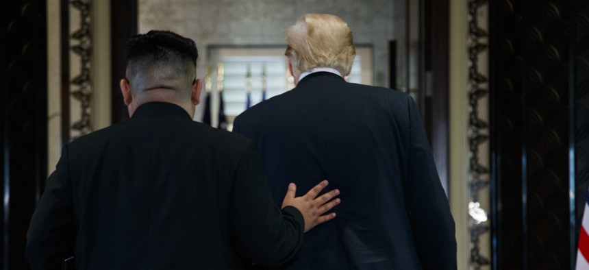 President Donald Trump and North Korean leader Kim Jong Un participate in a signing ceremony during a meeting on Sentosa Island, Tuesday, June 12, 2018, in Singapore.