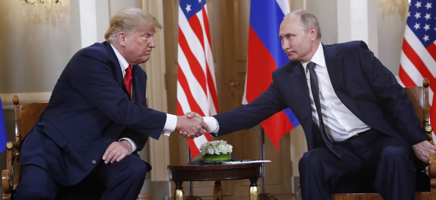 U.S. President Donald Trump, left, and Russian President Vladimir Putin shake hand at the beginning of a meeting at the Presidential Palace in Helsinki, Finland, Monday, July 16, 2018.