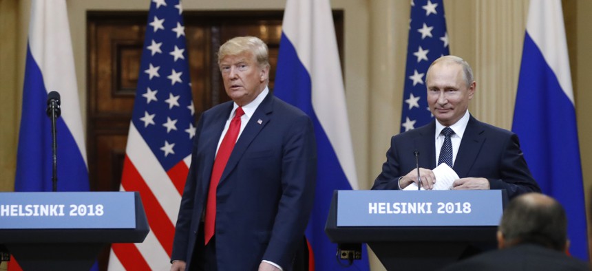 U.S. President Donald Trump, left, and Russian President Vladimir Putin arrive for a press conference in Helsinki, Finland, Monday, July 16, 2018.