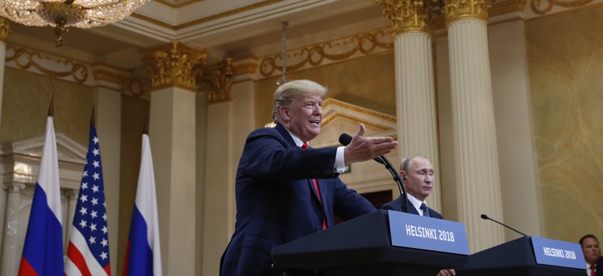 U.S. President Donald Trump, center, gestures while speaking as Russian President Vladimir Putin looks on during their joint news conference at the Presidential Palace in Helsinki, Finland, Monday, July 16, 2018.
