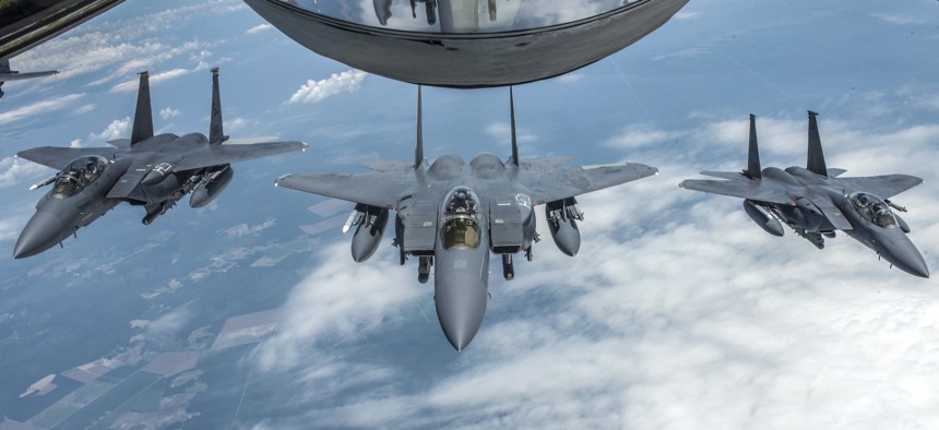 F-15E Strike Eagles with the 4th Fighter Wing at Seymour Johnson Air Force Base, N.C., form up behind a KC-135 Stratotanker with the 121st Air Refueling Wing, Ohio Air National Guard, June 15, 2018.