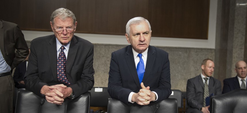 Senate Armed Services Committee Chairman James Inhofe, R-Ok., left and ranking member Jack Reed, D-R.I., talk before a hearing in March 2018.