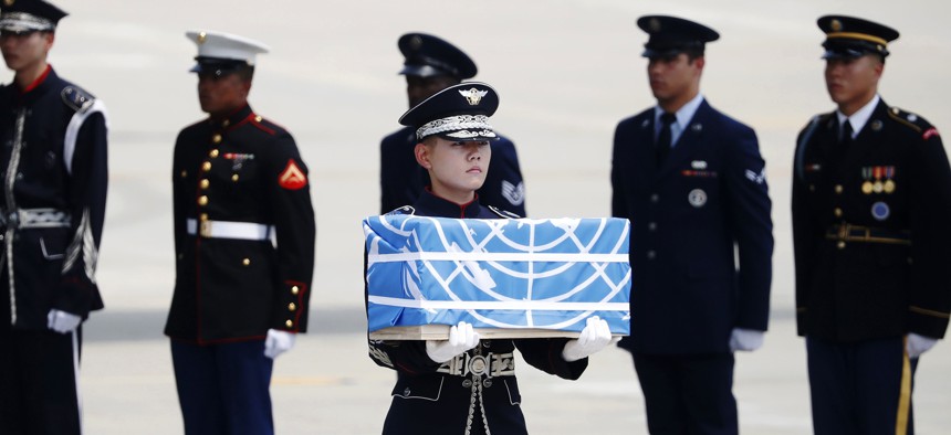 A soldier carries a casket containing a remain of a U.S. soldier who was killed in the Korean War during a ceremony at Osan Air Base in Pyeongtaek, South Korea, July 27, 2018. The U.N. Command said the 55 cases of war remains retrieved from North Korea wi