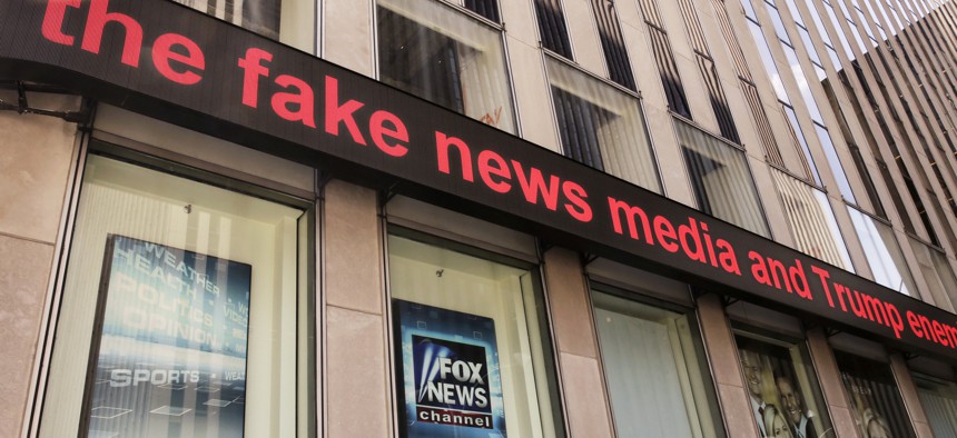 News headlines scroll above the Fox News studios in the News Corporation headquarters building in New York, Tuesday, Aug. 1, 2017. Fox contributor Rod Wheeler, who worked on the Seth Rich case, claims Fox News fabricated quotes implicating Rich.