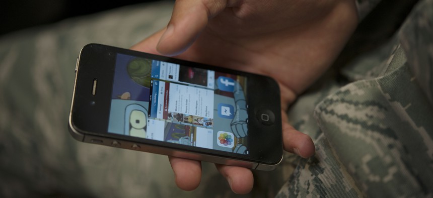 An airman scrolls through applications on a cellphone Jan. 31, 2014, at Incirlik Air Base, Turkey. 