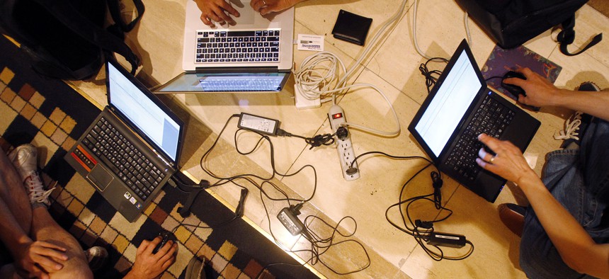 Hackers participate in a competition at the DefCon conference Friday, Aug. 5, 2011, in Las Vegas.
