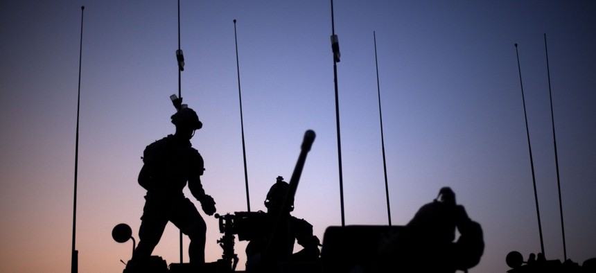 Soldiers with the Canadian Army's 1st Battalion 22nd Royal Regiment prepare for an operation at sunrise Monday, June 27, 2011 on Forward Operating Base Sperwan Ghar in the Panjwaii district of Kandahar province, Afghanistan