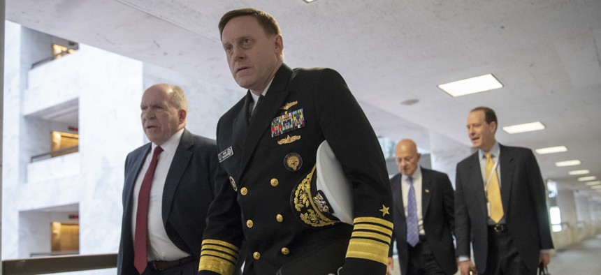 From left, former CIA Director John Brennan, former National Security Agency Director Michael Rogers, and James Clapper, former director of National Intelligence, arrive to talk with senators about Moscow's meddling in the 2016 campaign on May 16, 2018.