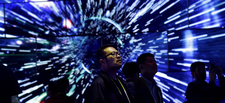 Bao Truong looks at a display of Samsung SUHD Quantum dot display TVs at the Samsung booth during CES International, Friday, Jan. 8, 2016, in Las Vegas