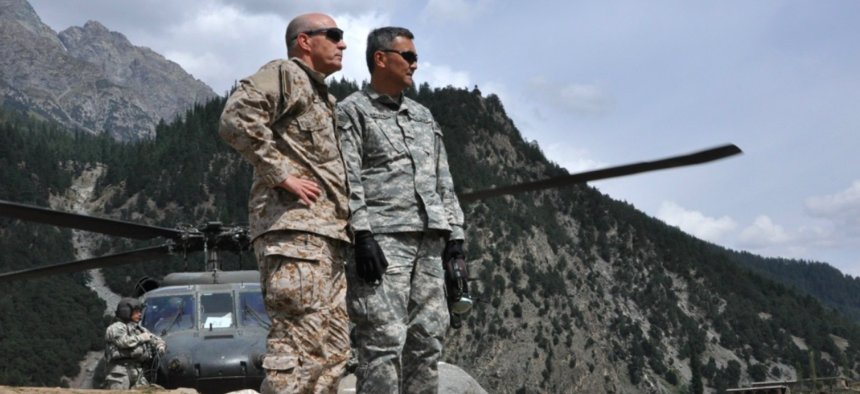 Brig. Gen. Mike Nagata, (left) deputy chief of the Office of the Defense Representative Pakistan and Vice Admiral Mike LeFever, commander of ODRP, watch as relief supplies are offloaded from a U.S. Army UH-60 Black Hawk in Uthror, Pakistan in 2010. 