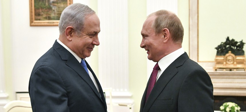 In this Wednesday, July 11, 2018 file photo, Russian President Vladimir Putin, right, shakes hands with Israeli Prime Minister Benjamin Netanyahu during their meeting at the Kremlin in Moscow.