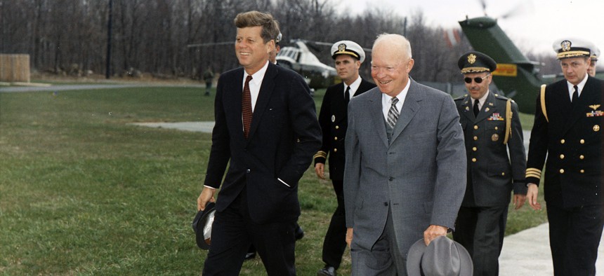 Meeting with President Eisenhower. President Kennedy, President Eisenhower, military aides in Camp David, Maryland, April 22, 1961.