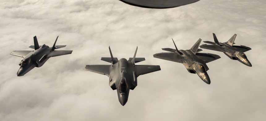 Two F-22 Raptors fly with two Norwegian F-35s in Norway.