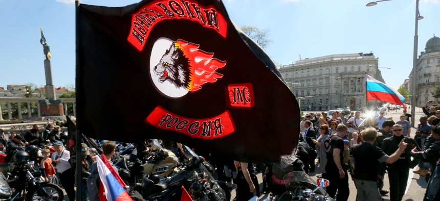 Members and supporters of the Russian motorcycle club Night Wolves arrive at the heroes' monument of the Red Army, background left, in downtown Vienna, Austria, Friday, May 6, 2016.