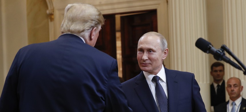 U.S. President Donald Trump, left, and Russian President Vladimir Putin, right, shake hands at the conclusion of their joint news conference at the Presidential Palace in Helsinki, Finland, Monday, July 16, 2018.