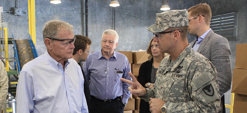 Col. Sean M. Herron (right), commander, McAlester Army Ammunition Plant, Oklahoma, talks to Sen. James Inhofe (R-Okla.) about the different ingredients that are loaded into a bomb body.