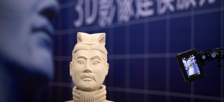 Video cameras scan a replica of a terra-cotta warrior figure at the 21st China Beijing International High-tech Expo in Beijing, China, Friday, May 18, 2018. The annual expo is a showcase of China's state-of-the-art technologies and cutting-edge ideas.