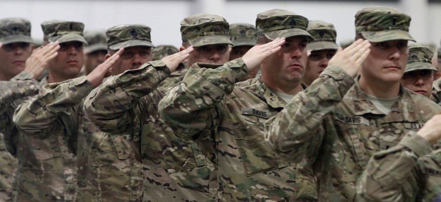 Soldiers from 2nd Battalion, 162nd Infantry Regiment, Oregon Army National Guard, render a salute during the National Anthem at their demobilization ceremony in Albany, Oregon, June 13, 2017.