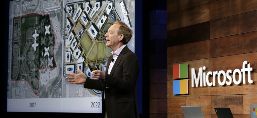 Microsoft president Brad Smith talks about the expansion of the company's headquarters, shown on a screen behind, at the annual Microsoft shareholders meeting, Wednesday, Nov. 29, 2017, in Bellevue, Wash.