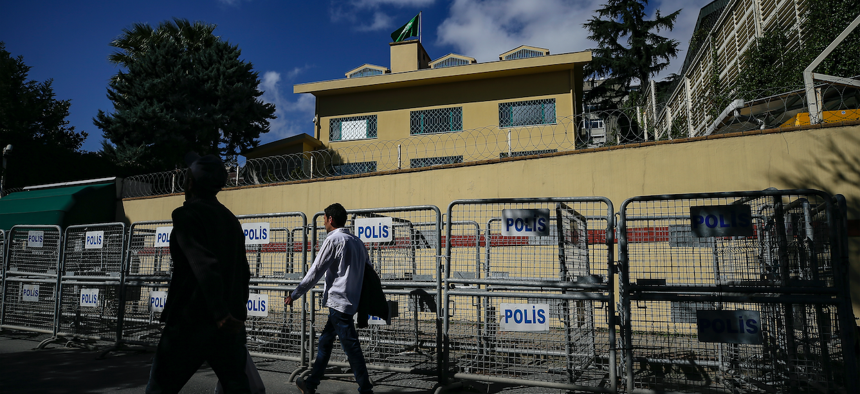People walk past the the Saudi Arabian consulate in Istanbul, Sunday, Oct. 7, 2018.
