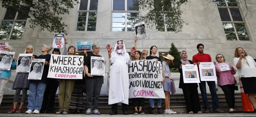 People hold signs at the Embassy of Saudi Arabia during protest about the disappearance of Saudi journalist Jamal Khashoggi, Wednesday, Oct. 10, 2018, in Washington. 