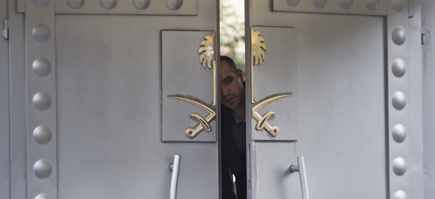 A security personnel looks out from the entrance of the Saudi Arabia's consulate in Istanbul, Sunday, Oct. 14, 2018.