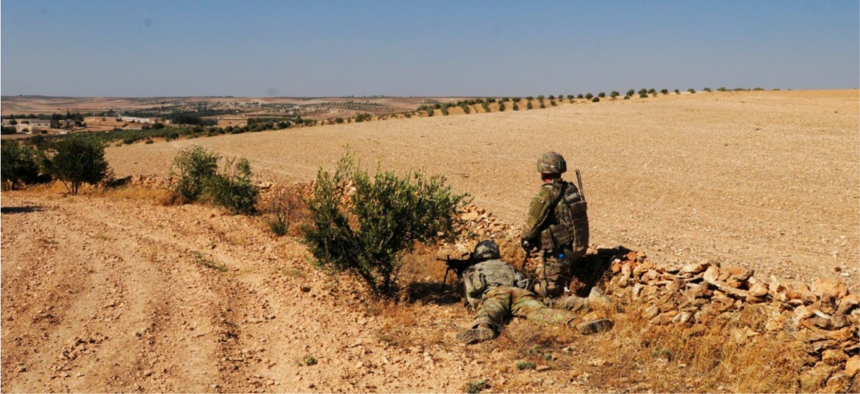 U.S. Soldiers provide security during an independent, coordinated patrol outside Manbij, Syria, August 19, 2018. 