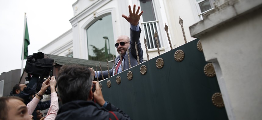 A security guard asks members of the media to back off, after rushing to cover the arrival of a group of a Saudi delegation that walked in the Saudi Arabia consul's residence in Istanbul, Wednesday, Oct. 17, 2018.