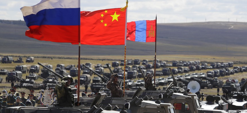 Russian, Chinese and Mongolian national flags set on armored vehicles develop in the wind during a military exercises on training ground "Tsugol", during the military exercises Vostok 2018 in Eastern Siberia, Russia, Sept. 13, 2018.