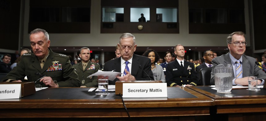 Defense Secretary Jim Mattis, center, flanked by Joint Chiefs Chairman Gen. Joseph Dunford, left, and Defense Undersecretary David Norquist, prepares to testify June 13, 2017, before a Senate Armed Services Committee.