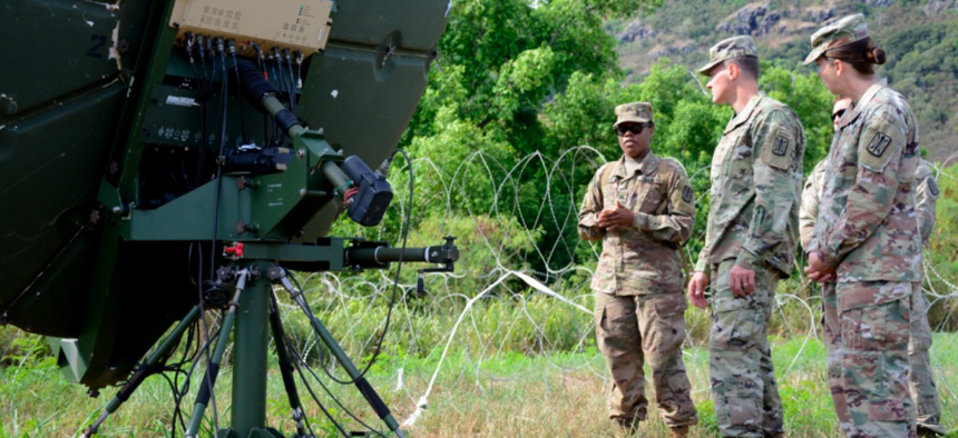 Sgt. Patricia Donaldson, a military systems maintainer/integrator assigned to 715th Military Intelligence Battalion, briefs colleagues on communications equipment during training exercise Lightning Forge on the Island of Oahu July 24, 2018.
