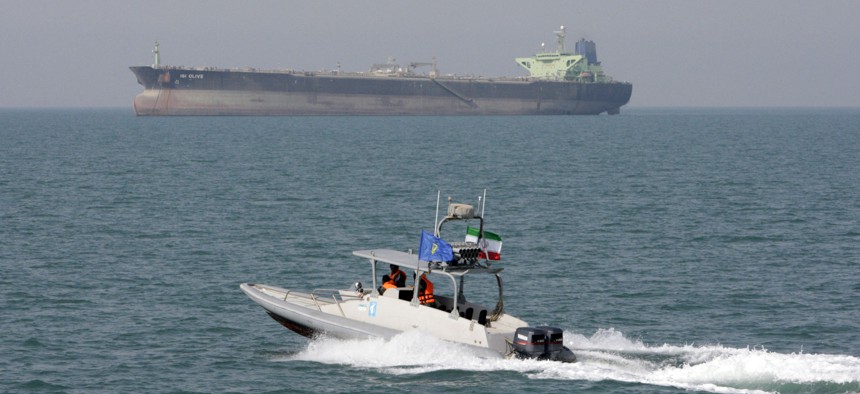  In this July 2, 2012 file photo, an Iranian Revolutionary Guard speedboat moves in the Persian Gulf while an oil tanker is seen in background.