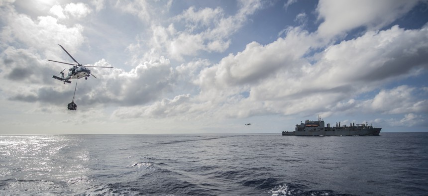 Military Sealift Command fleet replenishment oiler USNS John Ericsson (T-AO 194) and MH-60S Seahawk helicopters from the Island Knights of Helicopter Sea Combat Squadron (HSC) 25 participate in an exercise in the South China Sea, Oct. 20, 2014. 