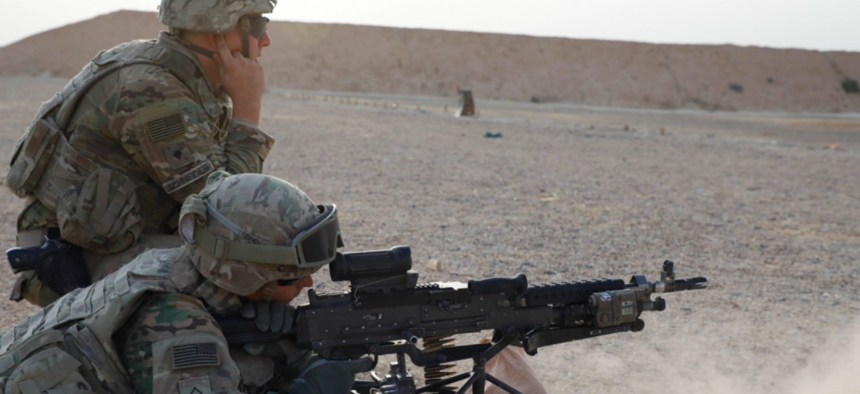 U.S. Army Spc. Matthew Schneider, assigned to Bandit Troop, 3rd Calvary Regiment, observes Pfc. Ryan Beineman, assigned to Bandit Troop, 3rd Calvary Regiment, firing a M240L during a weapon qualifying range in Iraq, Oct. 1 2018.